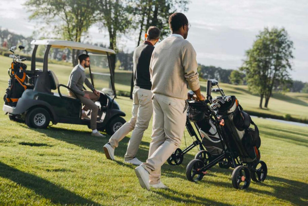 Golfers with a trolley on the course